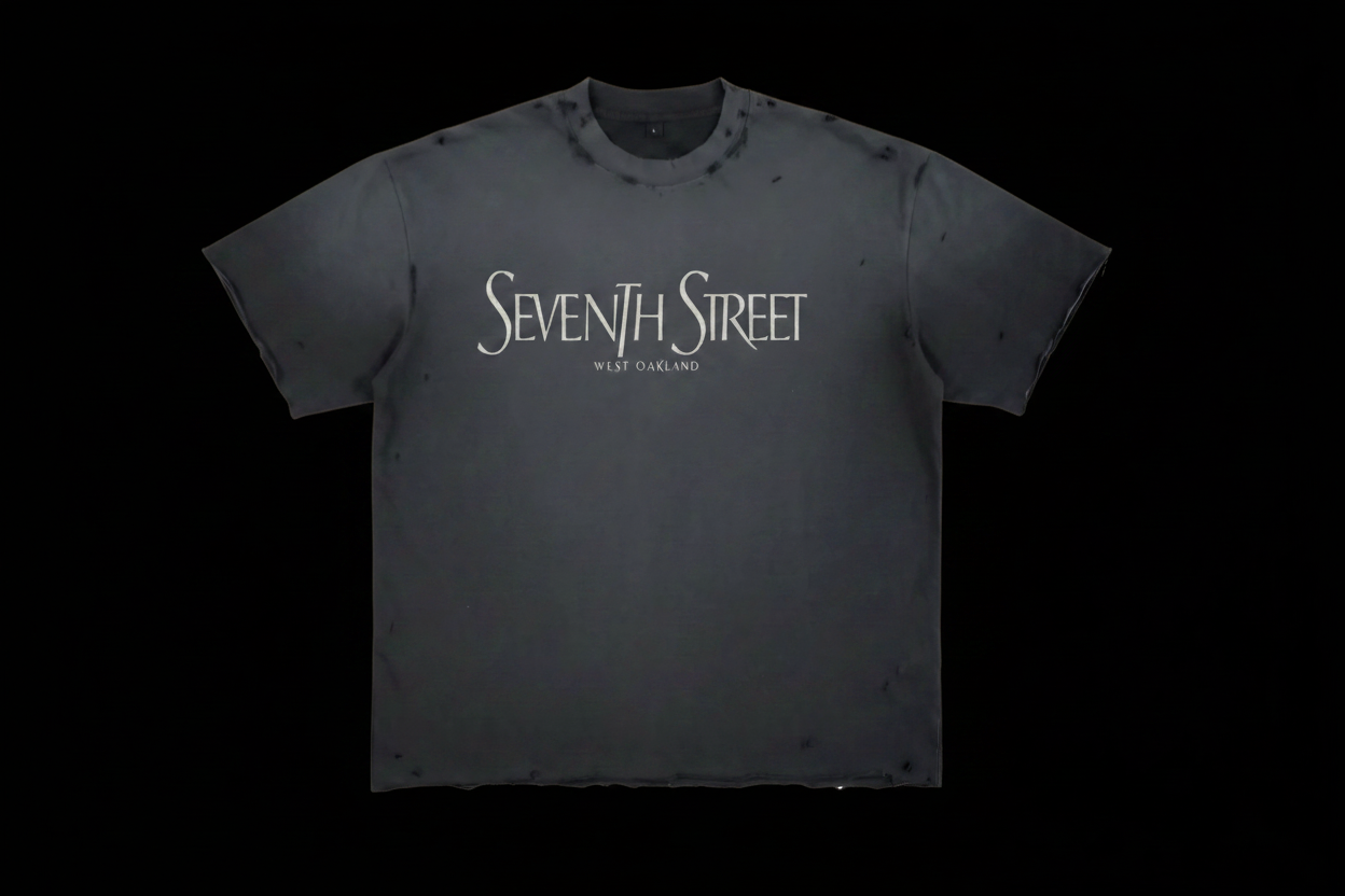Seventh Street West Oakland distressed charcoal tee with off-white serif text on black background